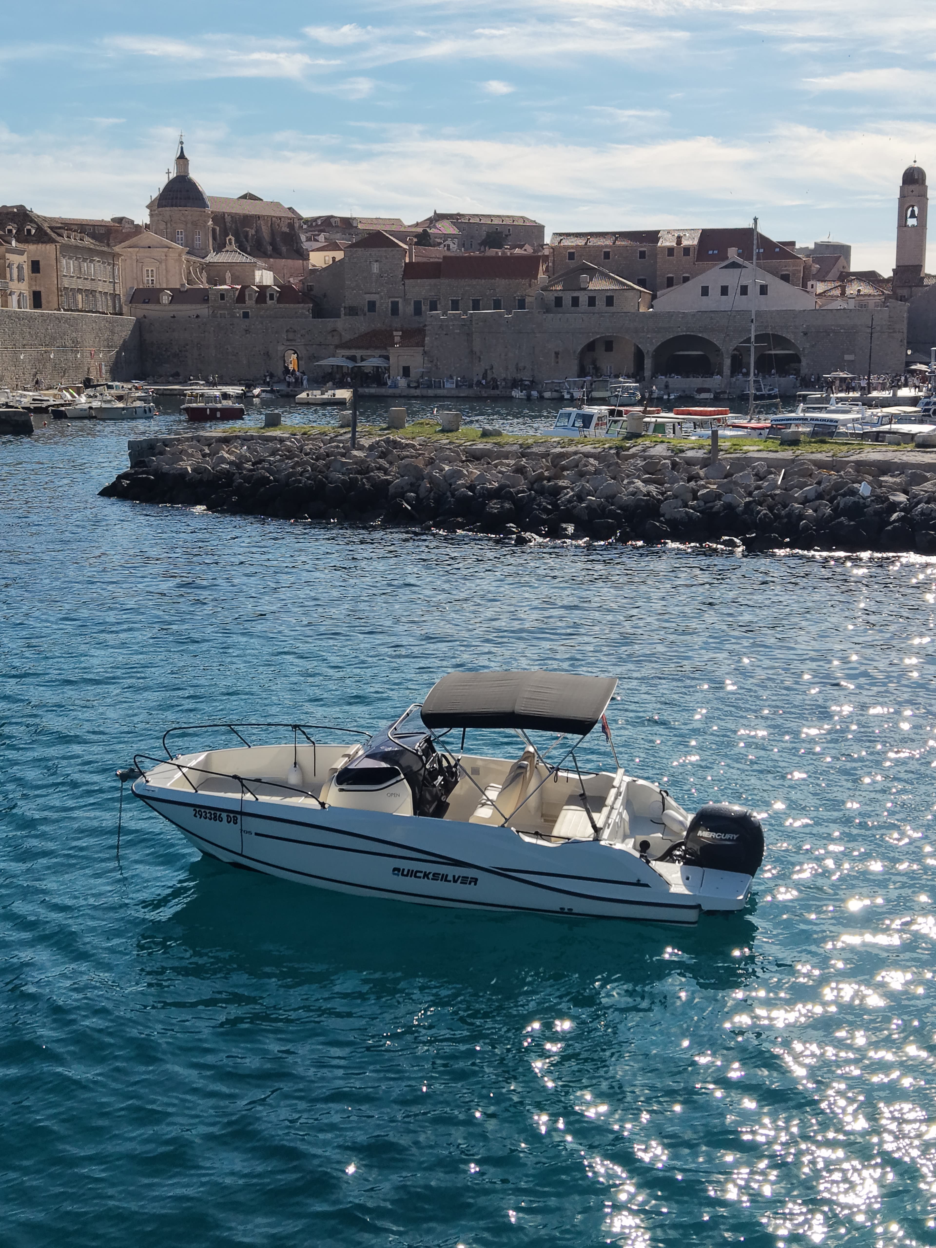 Quicksilver 705 Open anchored in a turquoise cove